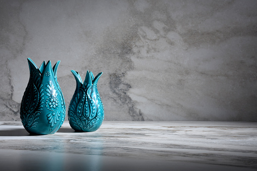 Two different size porcelain vases on the marble texture background with copy space