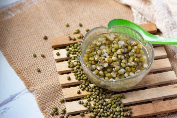 istock Green beans boiled sugar in a glass cup on a gray background 1323696395