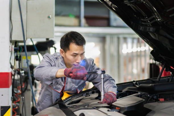 istock Auto mechanic uses a combination tool to rotate the screw 1323696728