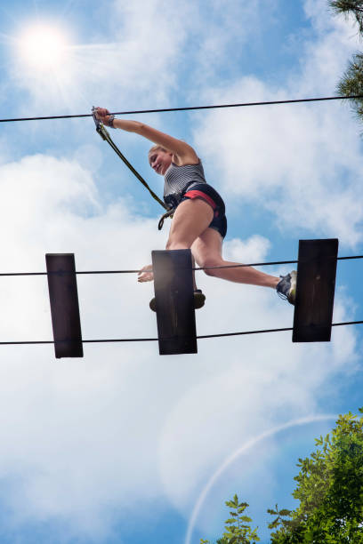 istock young woman in a treeclimbing park 1323697936