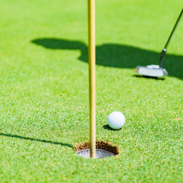 istock putter and golf ball on the green 1323698137