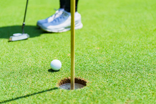 istock putter and golf ball on the green 1323698140