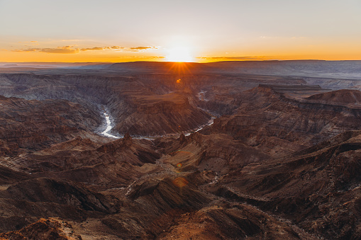 Dramatic panoramic view of the huge canyon with curved river during sunny colorful sunset in Namibia, Southern Africa