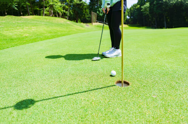 istock putter and golf ball on the green 1323698159