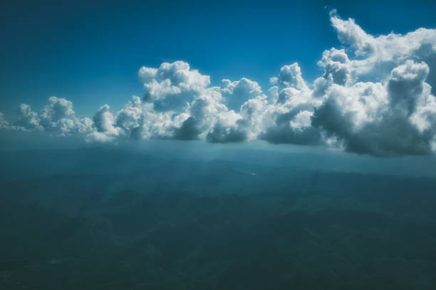 moody tone ; aerial view of mountain curve with cloud and ray of light at 9000 feet above ground , inspiration , calm and mindfulness concept - mountain range earth sky airplane imagens e fotografias de stock