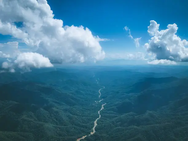 Photo of Aerial view of road crossing hill with dark blue sky and cloud in the north of thailand , hope and dream concept