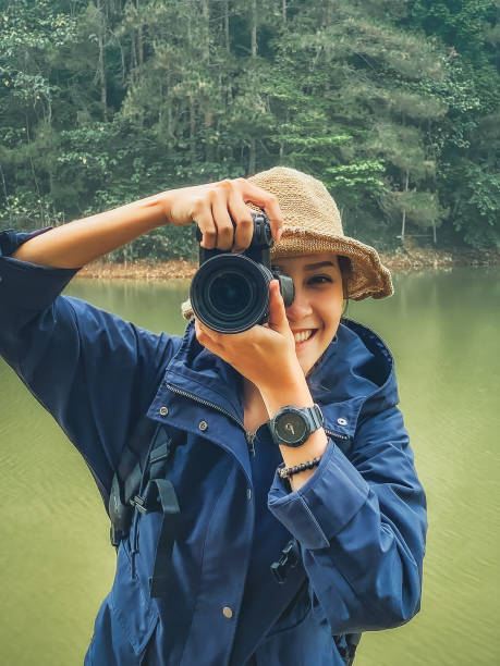 istock Front view young women in trekking suit progressing her camera , inspiration , freedom and recreation concept 1323699783