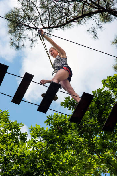 istock young woman in a treeclimbing park 1323700046
