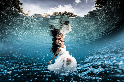 Mature woman underwater.