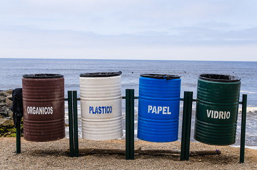 Colorful recycling bins for collecting recycled materials on the beaches of the Lima coast in Peru