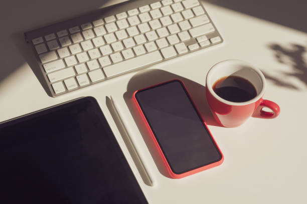 istock The desk with a coffee cuThe desk with a coffee cup, tablet,  phone, computer placed.p, tablet,  phone, computer placed. 1323705187
