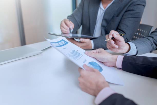 istock Businessman hand pointing at business document while discussing in the meeting. 1323705371