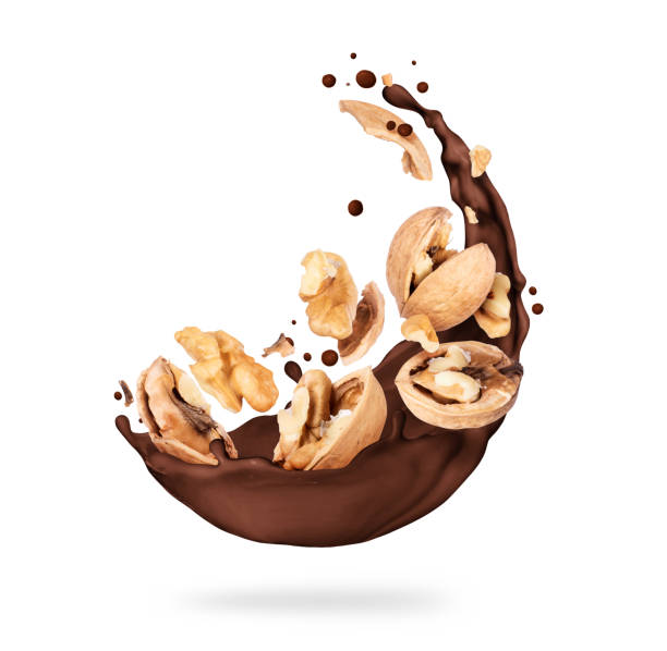 istock Chocolate splashes with walnuts close-up on a white background 1323706352