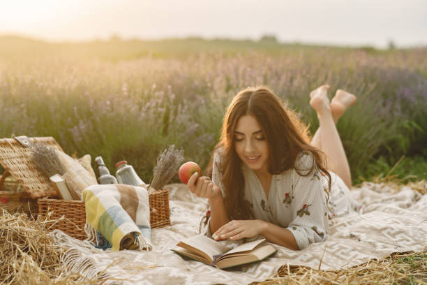 istock Woman in a lavender field sitting on a blanket 1323706680