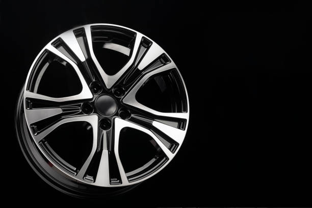 istock black with a polished front part suv car alloy wheel, copy space on a dark background 1323707298