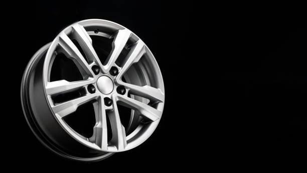 istock new beautiful silver alloy wheel on a black background. copy space 1323708415