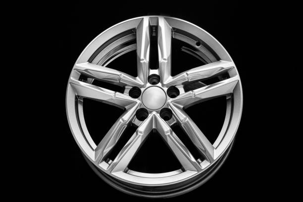 istock silver alloy wheel with bifurcated beams on a black background 1323708513
