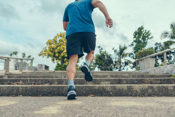 istock The man with running up the stair in sunset. 1323712642