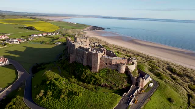 4k drone footage of Bamburgh Castle on the coast of Northumberland, UK