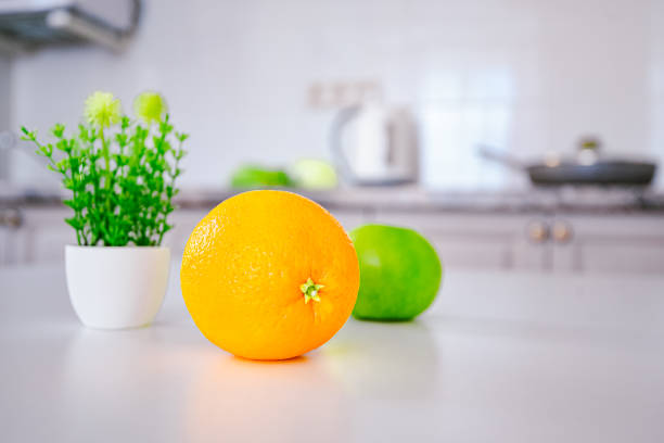 istock Fresh orange on wooden table in kitchen. Space for text 1323722538