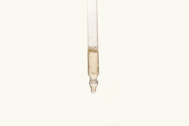 istock Pipette with essential oil on blurred flower background 1323726639