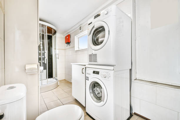 istock Shower and bathtub in light bathroom with washing machine 1323728106