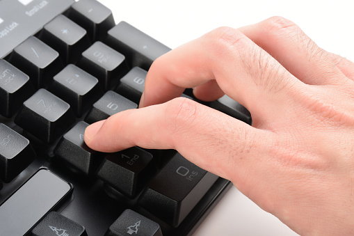 Close up of man hand typing on keyboard