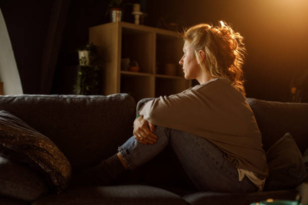 istock Woman sitting on the sofa and contemplating 1323731552