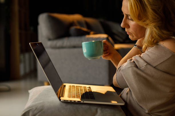 istock Woman having neck pain while working late 1323733502