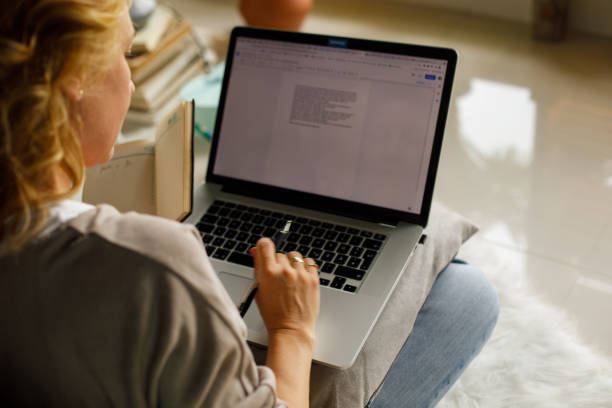 istock Over the shoulder view of woman using laptop 1323733637