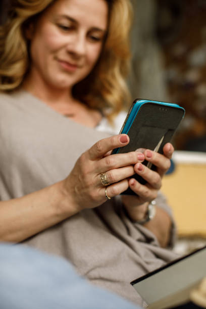 istock Selective focus shot of woman using smart phone 1323734207