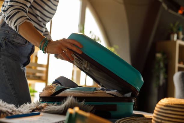istock Unrecognizable woman closing a suitcase after finishing packing 1323735291