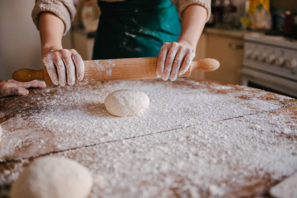 istock Woman rolling  the dough with rolling pin 1323735472