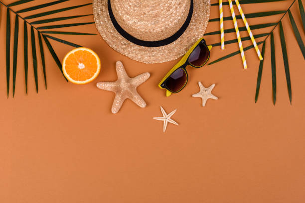 istock Beach accessories: glasses and hat with shells and sea stars on a colored background 1323735609