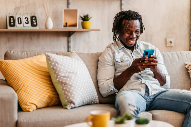 istock Handsome man relaxing at home and texting on phone 1323738451