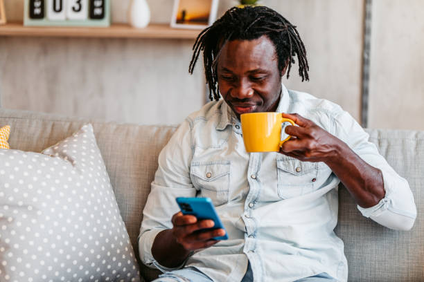 istock Handsome man relaxing at home and texting on phone 1323738500