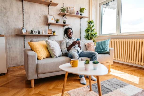 istock Handsome man relaxing at home and texting on phone 1323738696