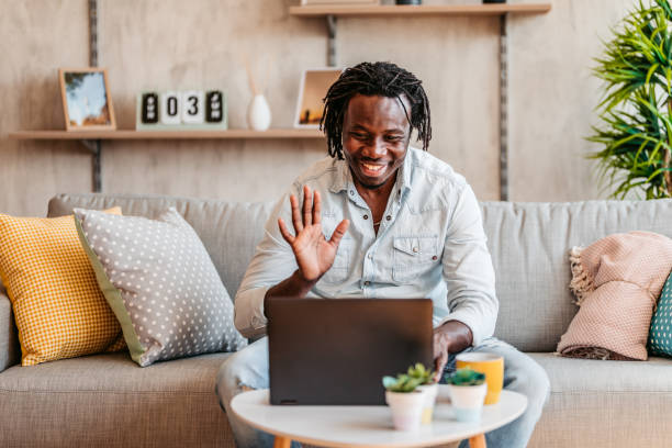 istock Man making online video call on laptop on sofa 1323739828