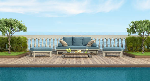 istock Retro style sofa and footstool by the pool in a garden with balustrade 1323739837