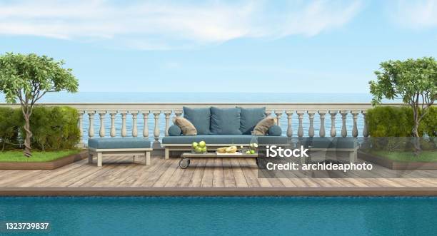 Retro Style Sofa And Footstool By The Pool In A Garden With Balustrade Stock Photo - Download Image Now