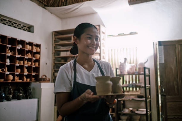 istock Young Woman Holding Pottery Vase She Made 1323739912