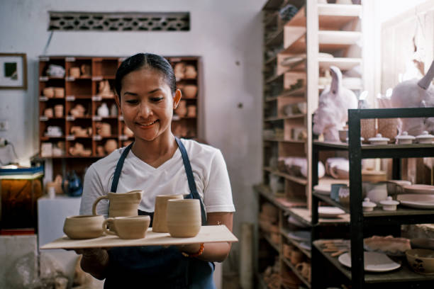 istock Young Woman Holding Pottery Vase She Made 1323740162