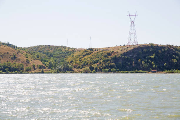 istock Danube river, water surface. Hills in the background with electricity towers. 1323741482