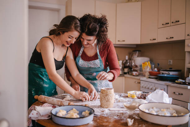 istock Mom and daughter in the kitchen making crescent rolls 1323741545