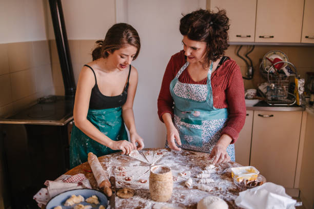 istock Mom and daughter in the kitchen making crescent rolls 1323741546