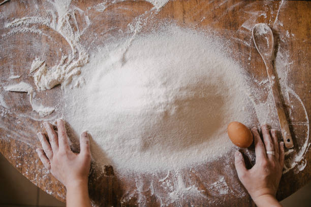 istock Woman preparing to add egg to the flour 1323744103