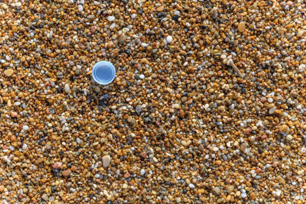 istock Plastic water bottle cap on the sand at the beach 1323747189