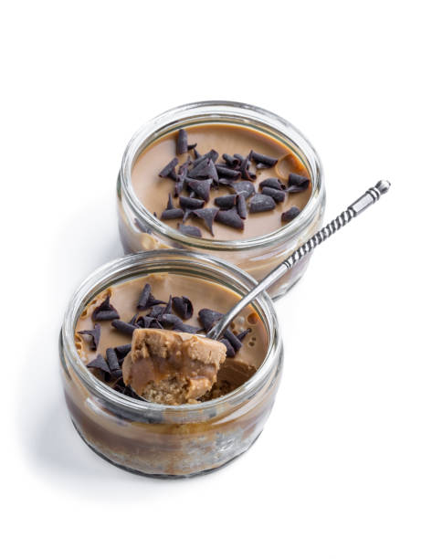 istock Mini caramel cheesecake in a glass pot isolated on white 1323752049