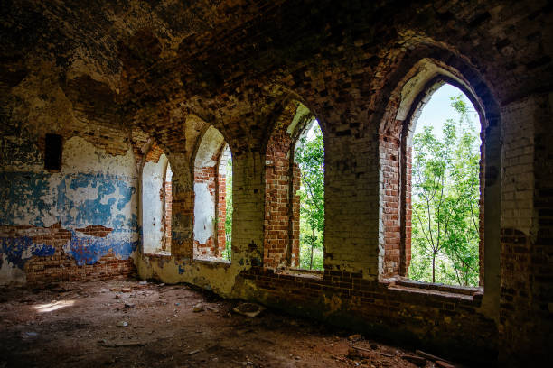 istock Inside the old ruined red brick church in gothic style 1323757615