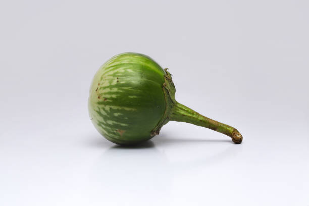 istock Green round eggplant isolated on white background 1323757710